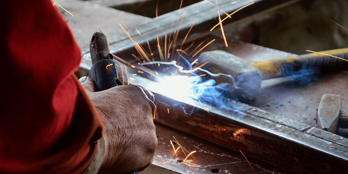 Welder welding stainless steel for a construction project | Cypress Fabrication